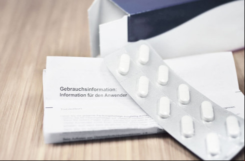 Tablet on top of a leaflet