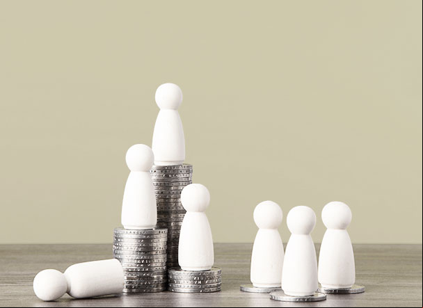 White wooden pegs positioned above stacks of silver coins